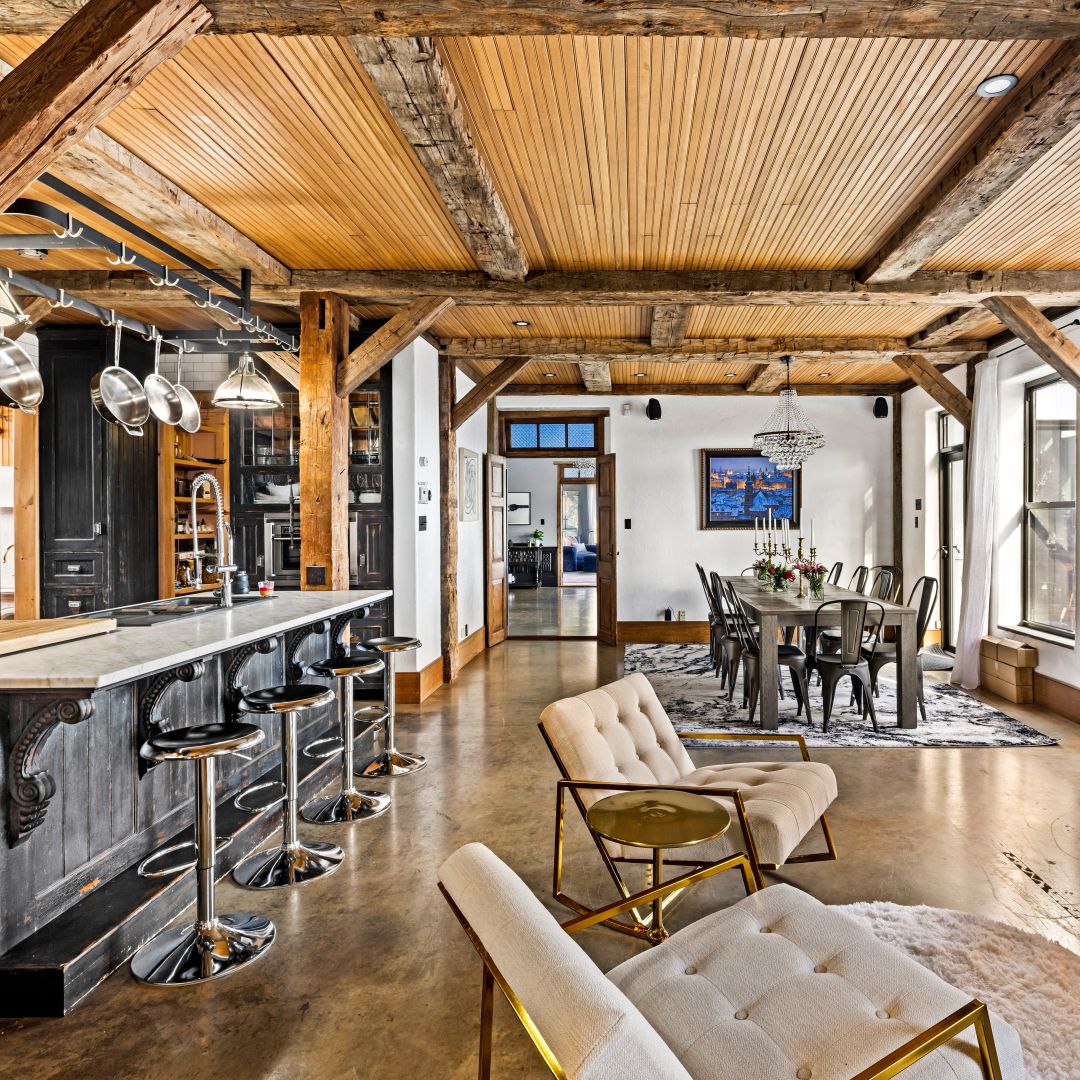 Chef's kitchen with reclaimed timber beams and marble island