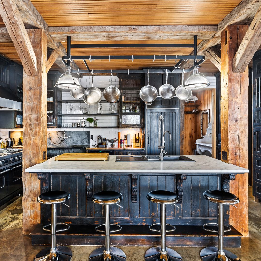 Marble island and copper pot rack in the chef's kitchen