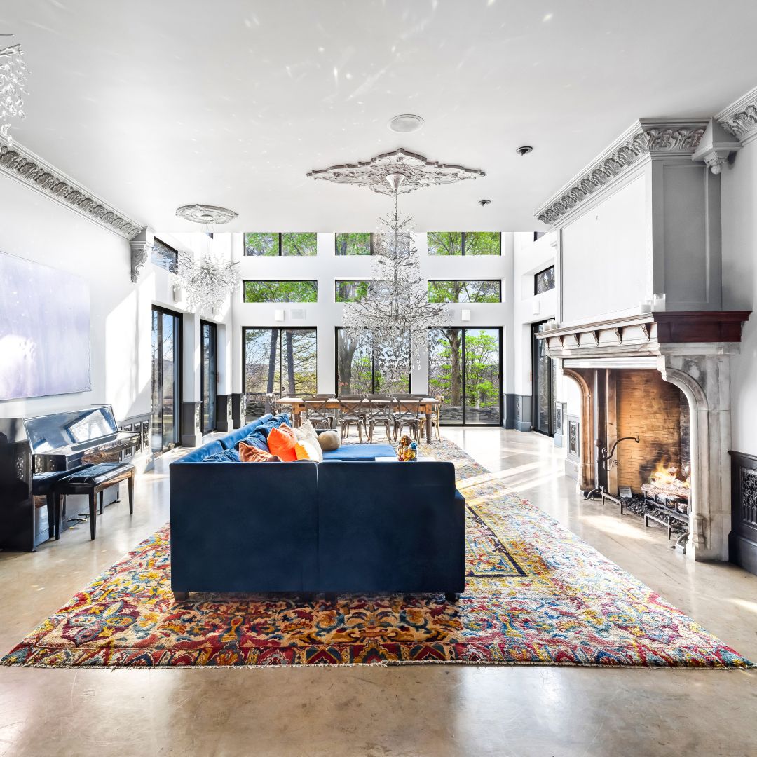 Great Room with antique fireplace, piano, and crystal chandeliers