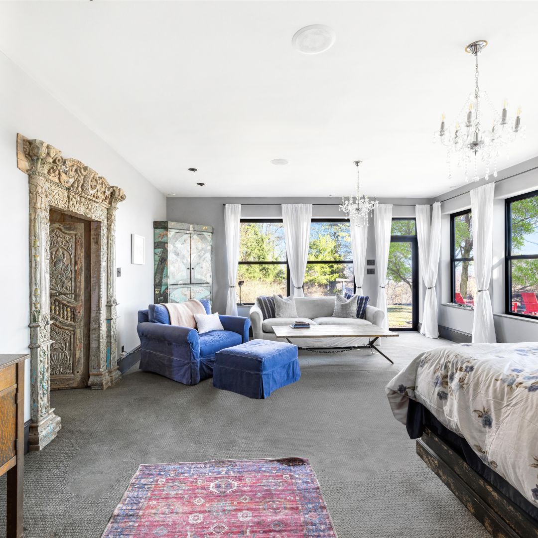 Primary suite with king bed and antique carved doorway